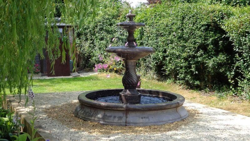 A feature fountain set within a two-tiered base pool