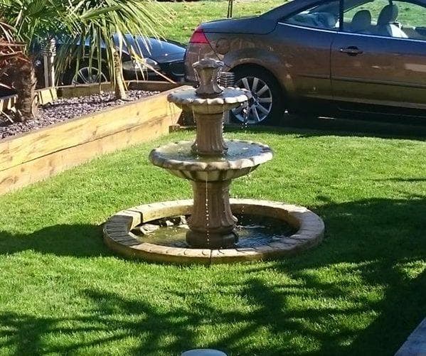 An in-ground fountain set low into a planted garden border