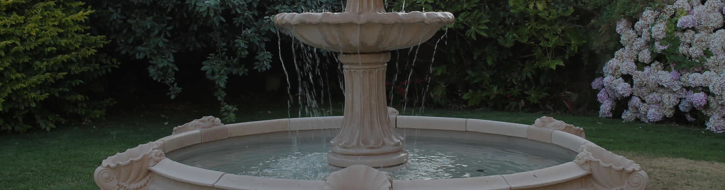 A round stone pool surround with blue water