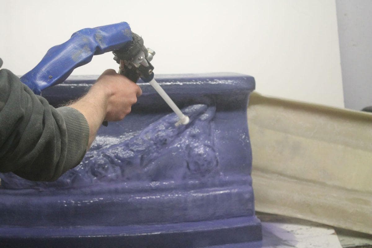Fibreglassing a mould in the workshop