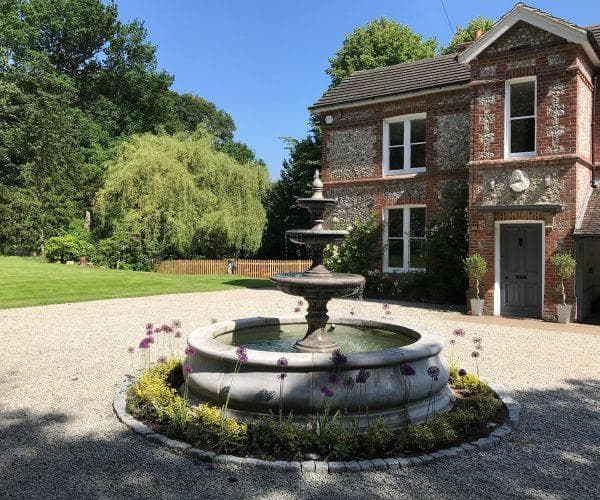 A two-tiered Windsor fountain with a Stanford pool surround